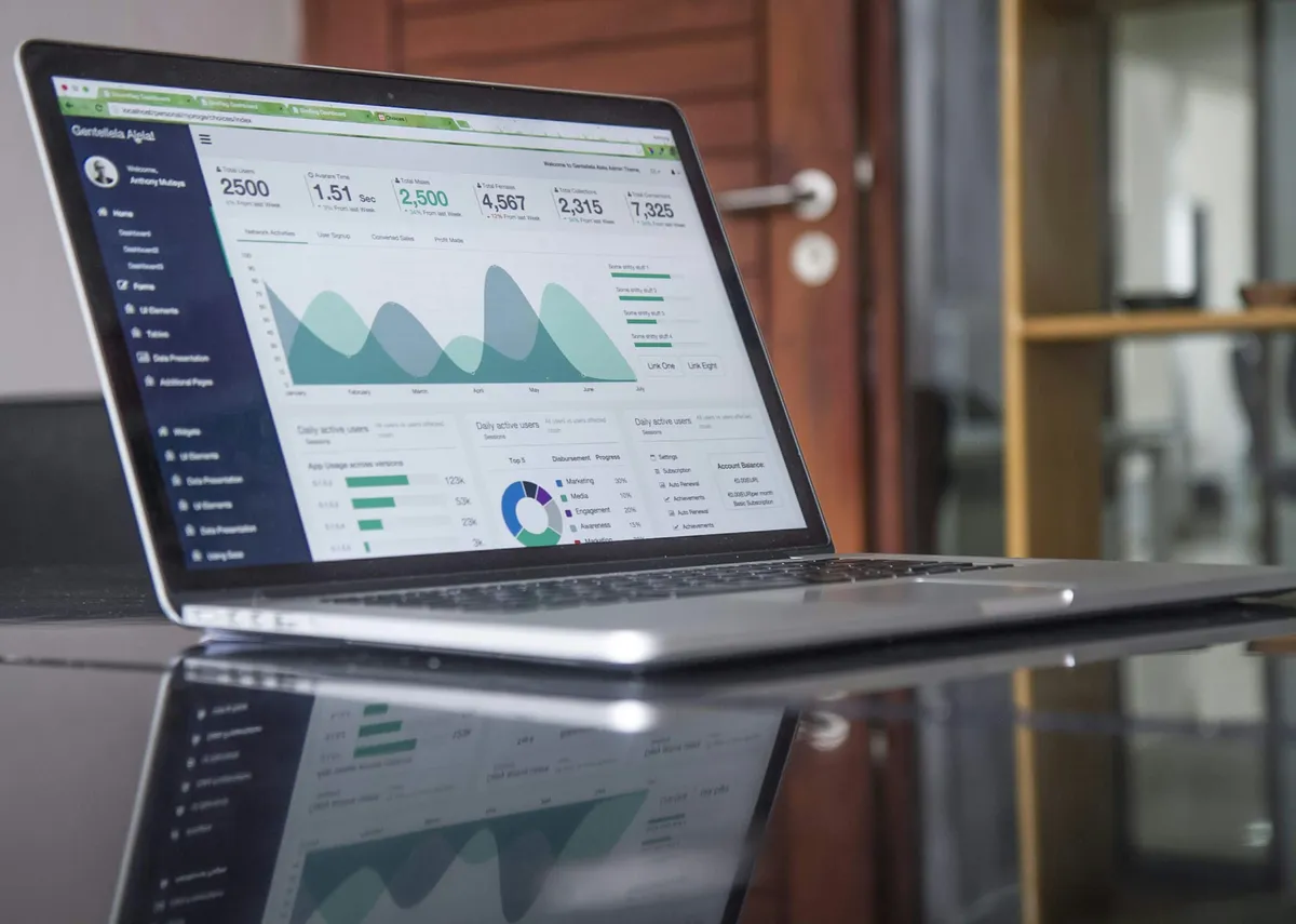 Laptop displaying SEO analytics dashboard with charts and metrics